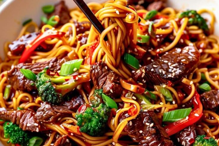 Savor **Authentic Chinese Food Near Me in NY** with this mouthwatering beef stir-fry noodle dish, loaded with fresh broccoli, red peppers, and sesame seeds for the perfect flavor balance!