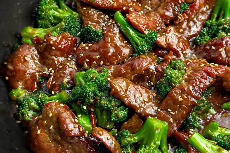 Enjoy **Authentic Chinese Food Near Me in NY** with this delicious beef and broccoli stir-fry, coated in a savory sauce and topped with sesame seeds for a perfect balance of flavor and texture!